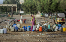 Woman gathers water in Karachi, Pakistan