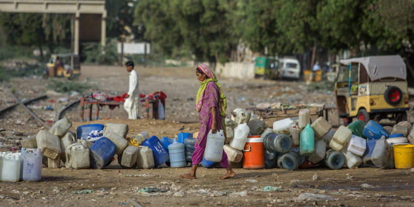 Woman gathers water in Karachi, Pakistan