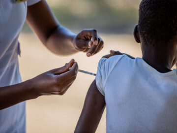 A child receives TCV during Zimbabwe's introduction campaign. Vaccines protect against typhoid during a drought when risk increases.