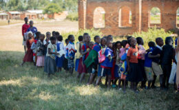 cost is an important component to introducing vaccines. Children wait to receive TCV during Malawi's integrated campaign.