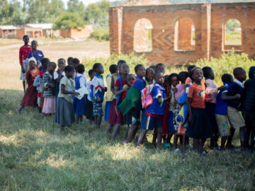 cost is an important component to introducing vaccines. Children wait to receive TCV during Malawi's integrated campaign.