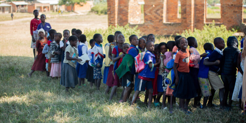 cost is an important component to introducing vaccines. Children wait to receive TCV during Malawi's integrated campaign.