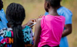 A picture of a girl receiving the typhoid conjugate vaccine (TCV) during an immunization campaign in Malawi.