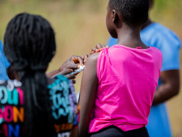 A picture of a girl receiving the typhoid conjugate vaccine (TCV) during an immunization campaign in Malawi.